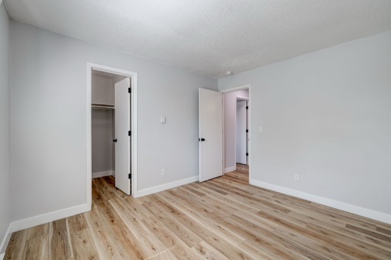 Bedroom with walk-in closet and new flooring at The Hampton Meadows
